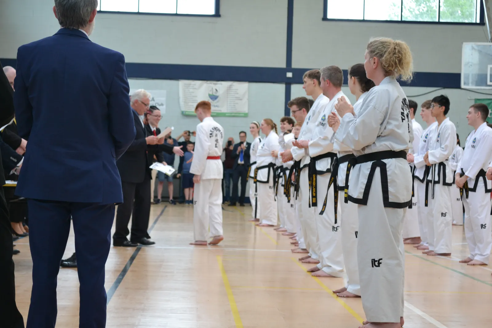 Black belt candidates standing in line for grading assessment